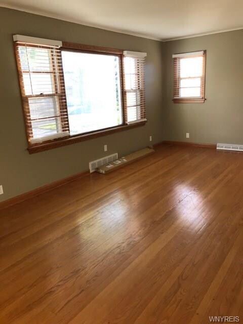 Large living room with wood floor and large window