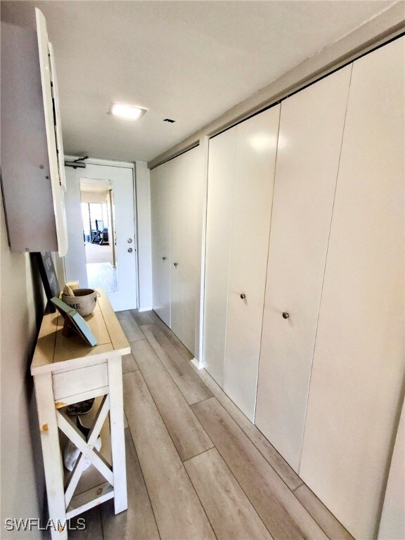 Hallway featuring light wood-style flooring