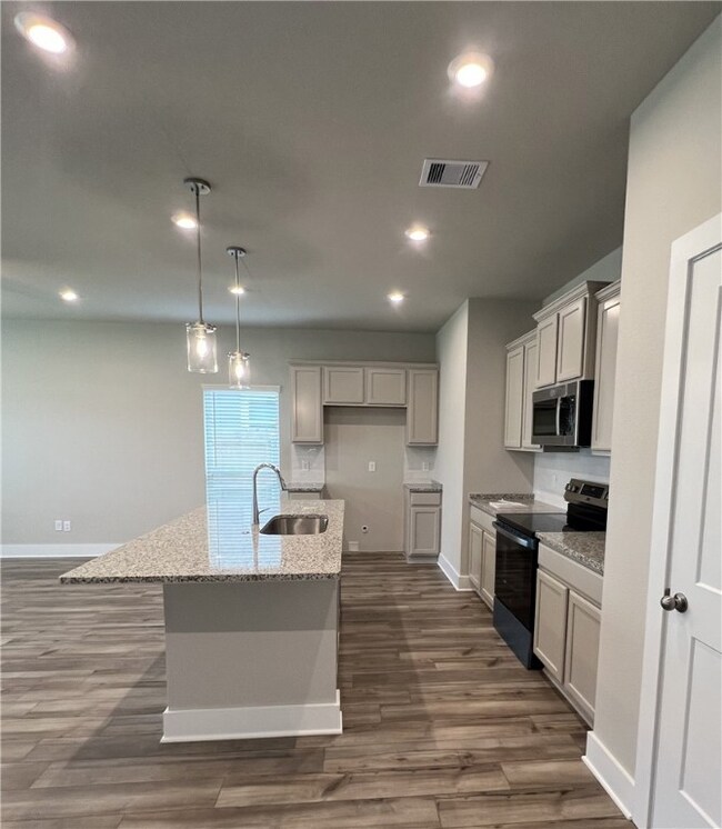 Kitchen with black electric range oven, stainless