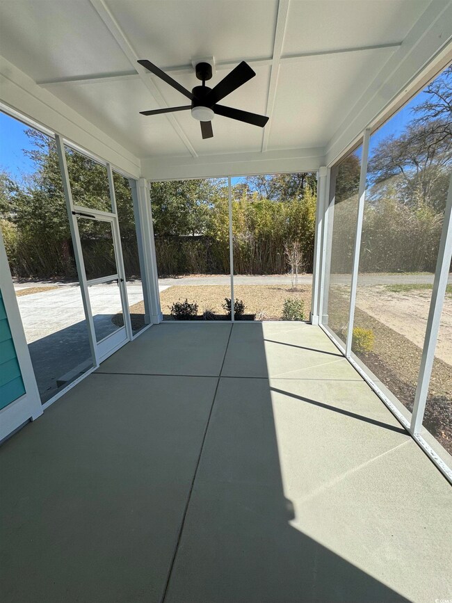 Unfurnished sunroom with ceiling fan