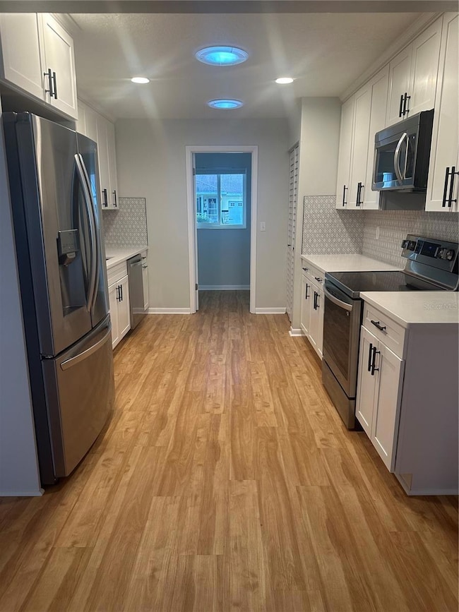 Kitchen, looking toward front of house and office area off of the kitchen.