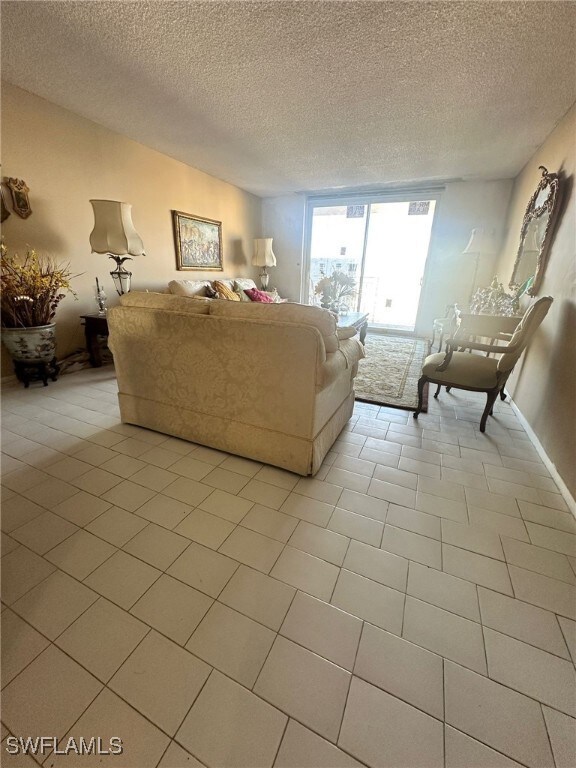 Unfurnished living room featuring light tile patte