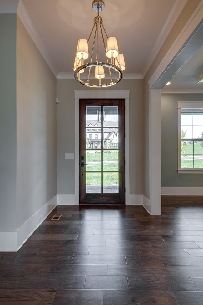 A reverse view of the foyer. Modern light fixture adds notable flare upon entering the home.