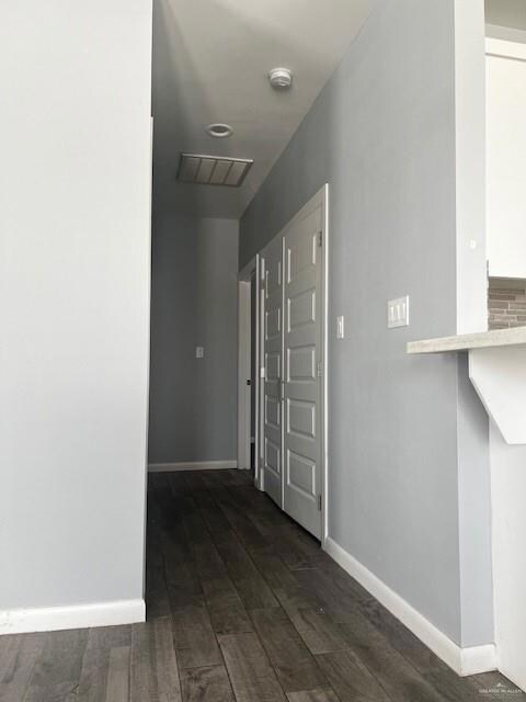 Corridor with dark hardwood / wood-style floors