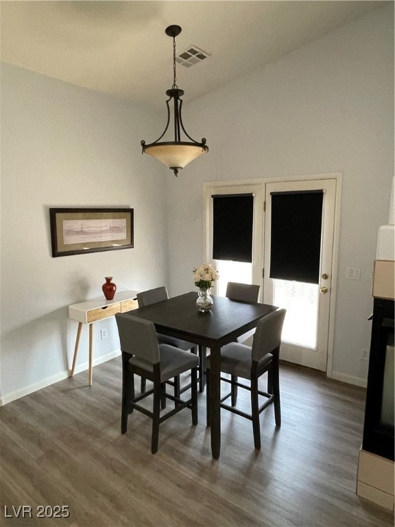 Dining space featuring dark wood-style flooring
