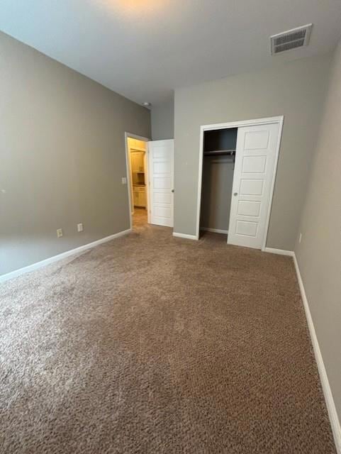 Unfurnished bedroom with carpet flooring, baseboa