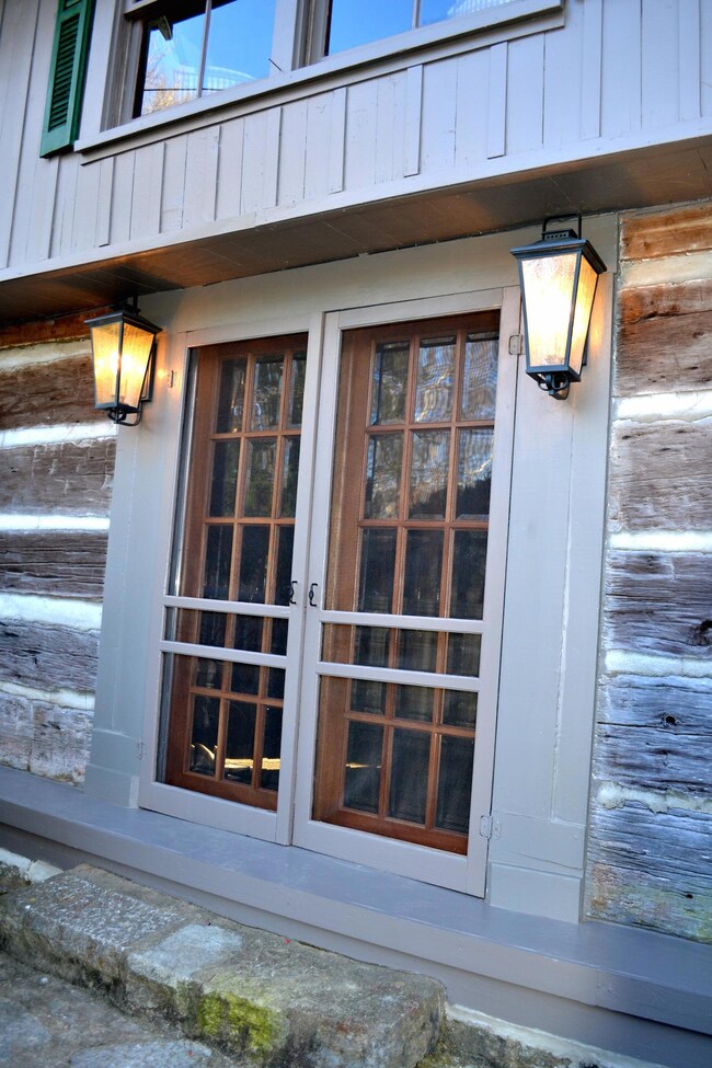 A close-up of the front doors, which also have screen doors.