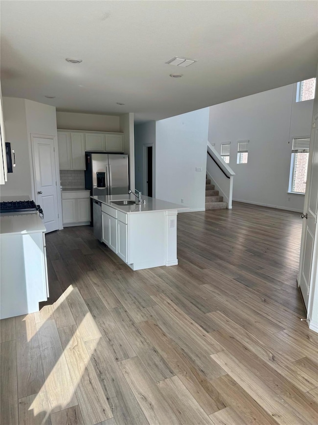 Kitchen featuring visible vents, light wood-type f