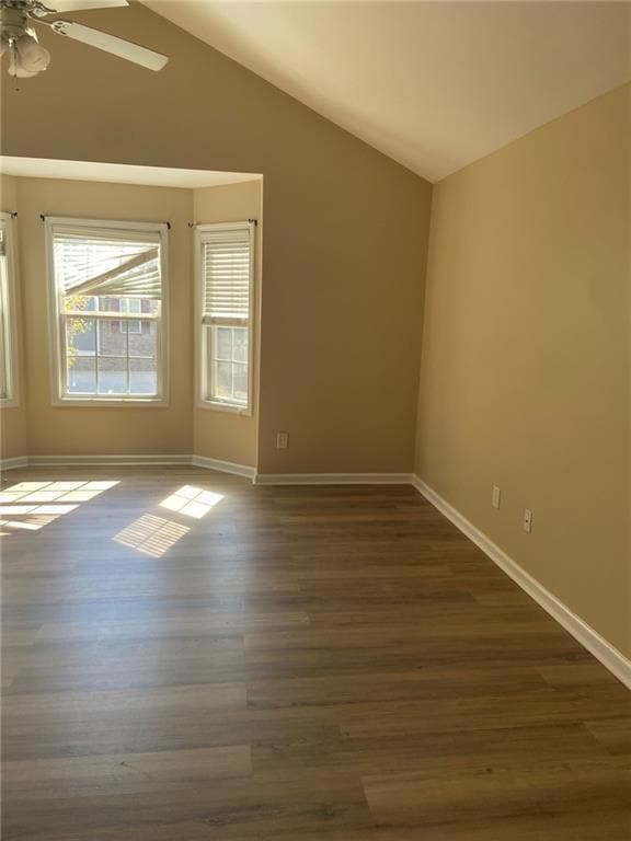 Spare room featuring lofted ceiling, ceiling fan, 