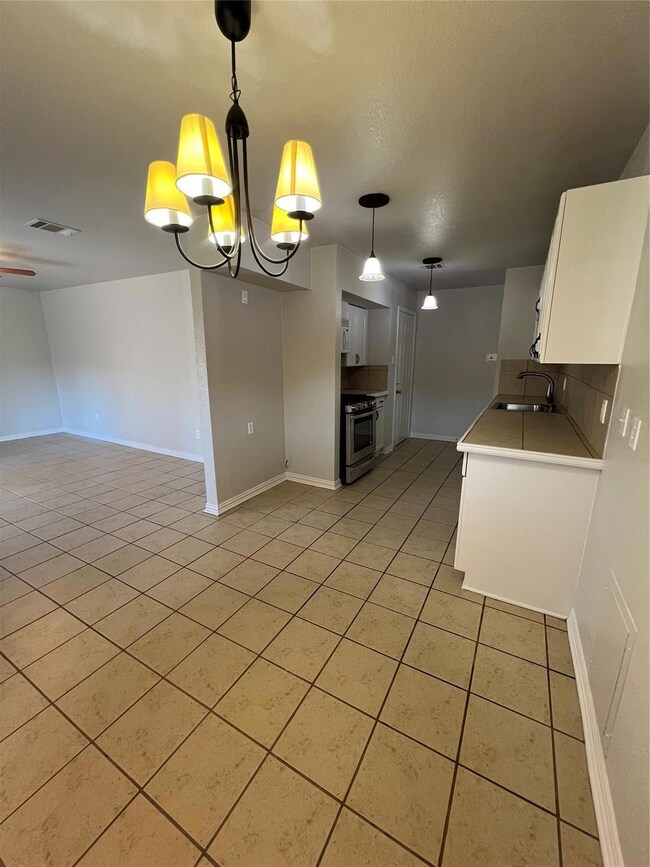 Kitchen with sink, white cabinets, stainless steel