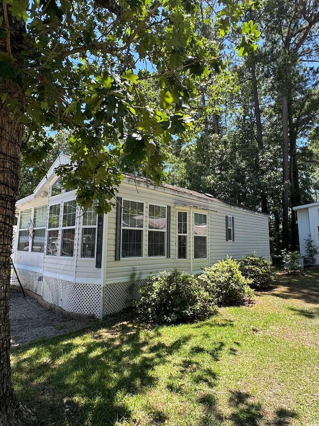 View of home's exterior with a yard