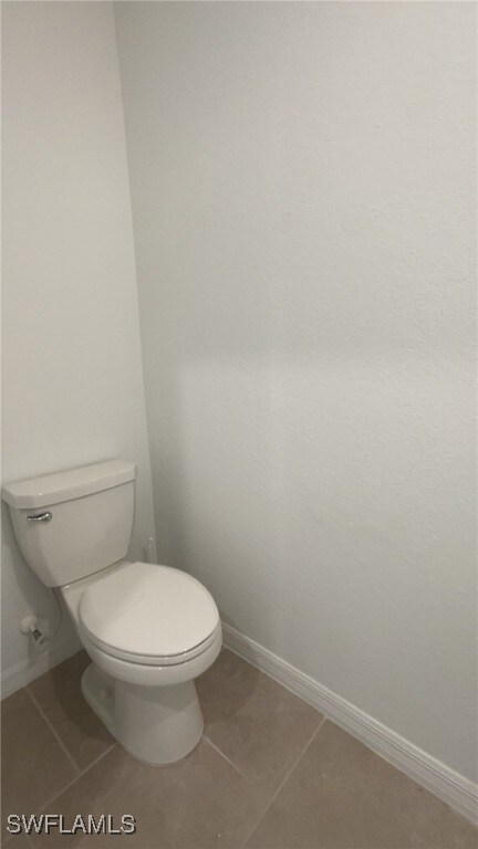 Bathroom with tile patterned floors and baseboards