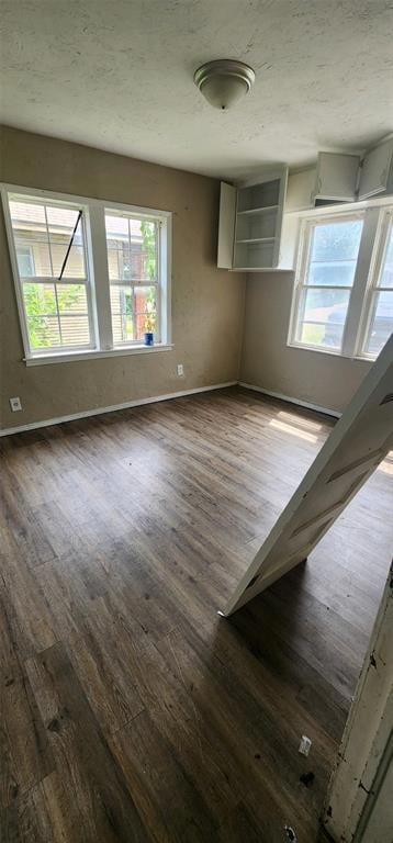 Empty room featuring plenty of natural light and h