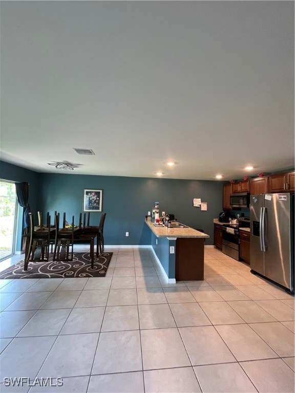 Kitchen featuring fridge, range, a peninsula, rece