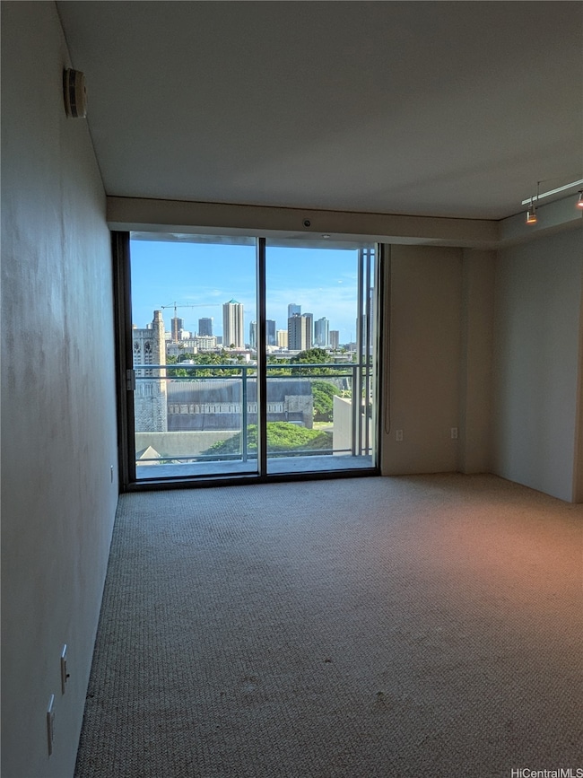 Living room has a lanai with views of the city.