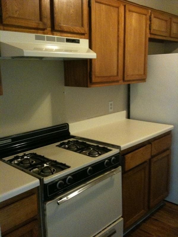 Kitchen featuring range with gas cooktop, brown c