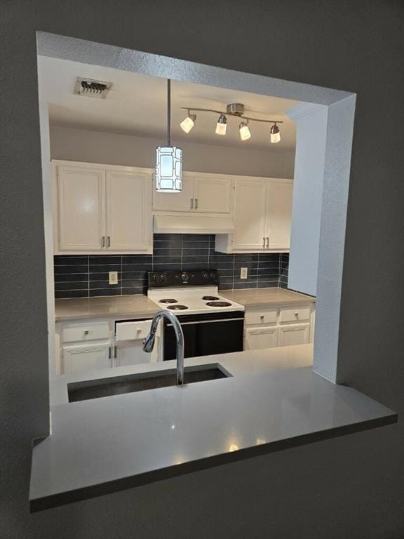 Kitchen with range with electric stovetop, under 