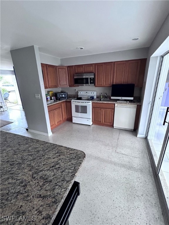 Kitchen with white range with electric stovetop an