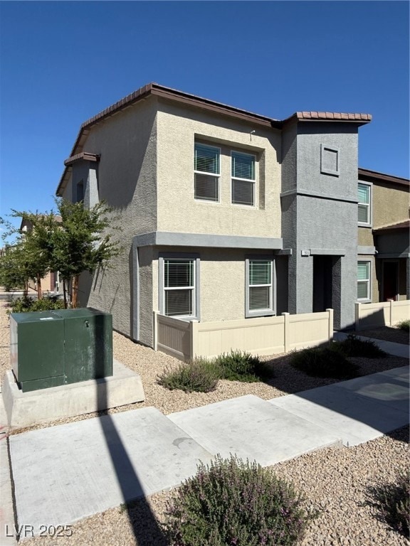 View of front of house featuring stucco siding, a