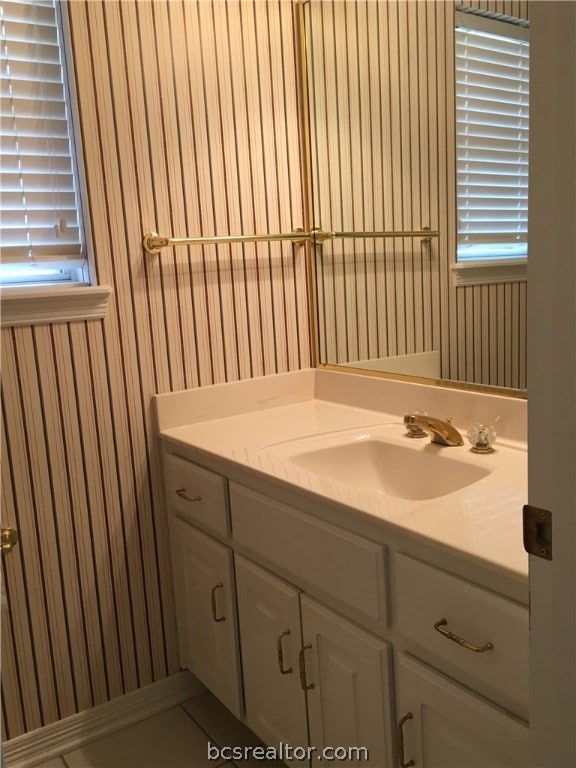 Half bath, powder room, located between laundry ro