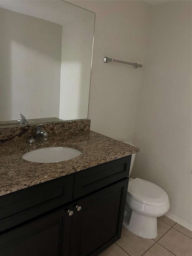 Bathroom featuring tile patterned floors, vanity, 
