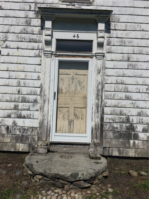 Cobble stone front walk with stone landing