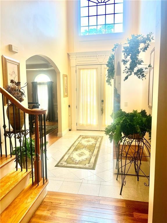 Foyer entrance featuring arched walkways, a toweri