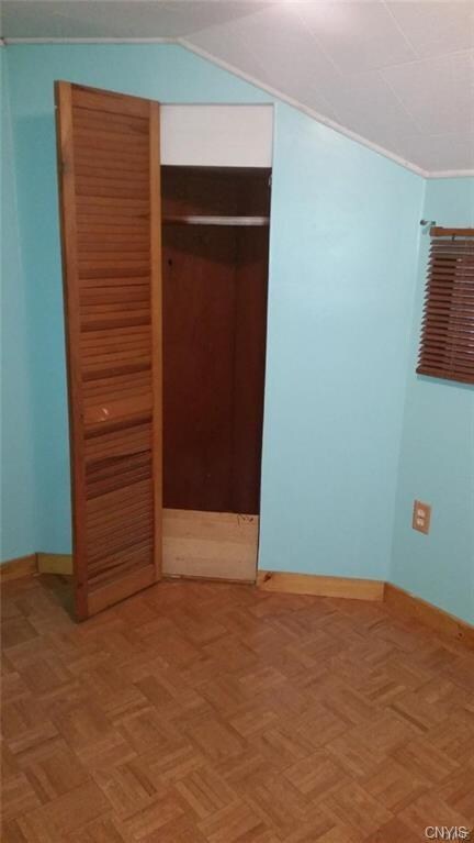Bedroom with parquet floors and plenty of closet s