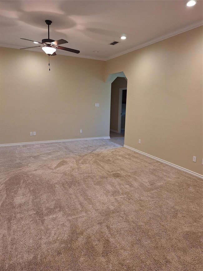 Family room featuring carpet flooring, ceiling fan