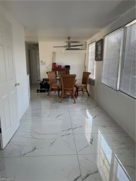 Dining area featuring marble finish floor, baseboa