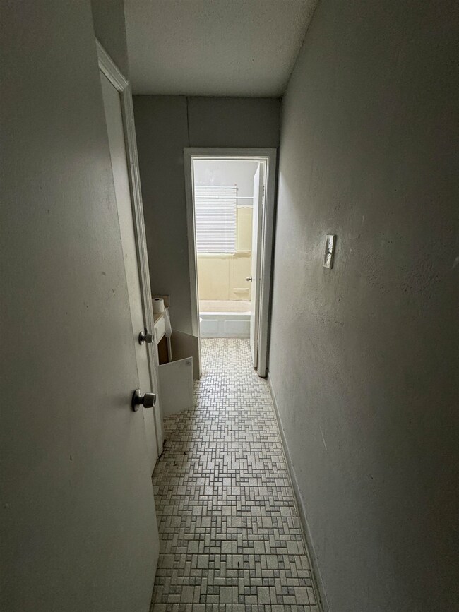 Hallway with tile flooring