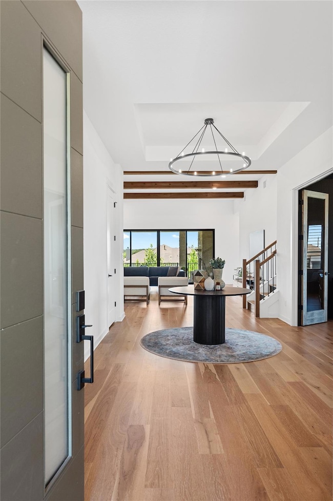 Living room with a tray ceiling, wood finished fl