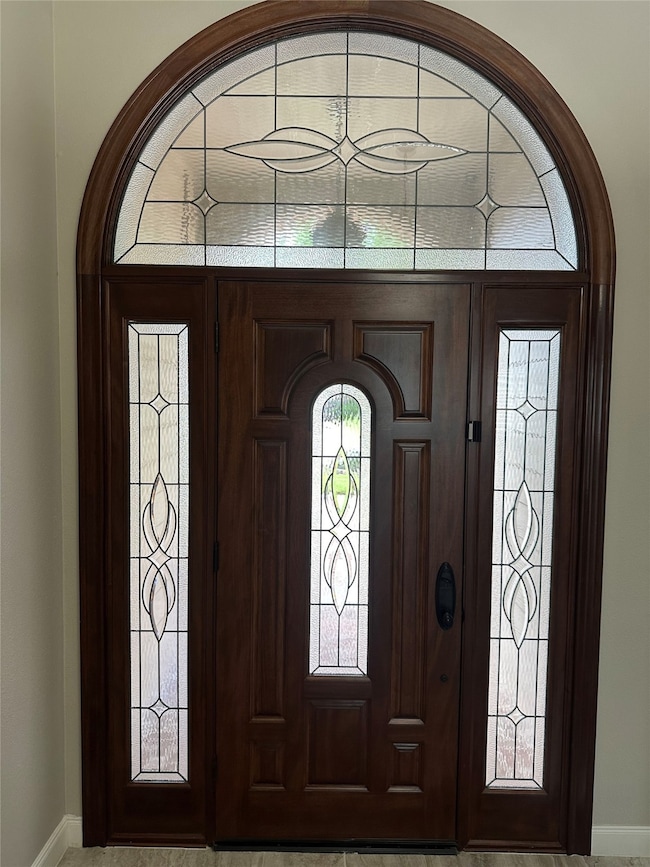 Elegant wooden front door with decorative glass pa