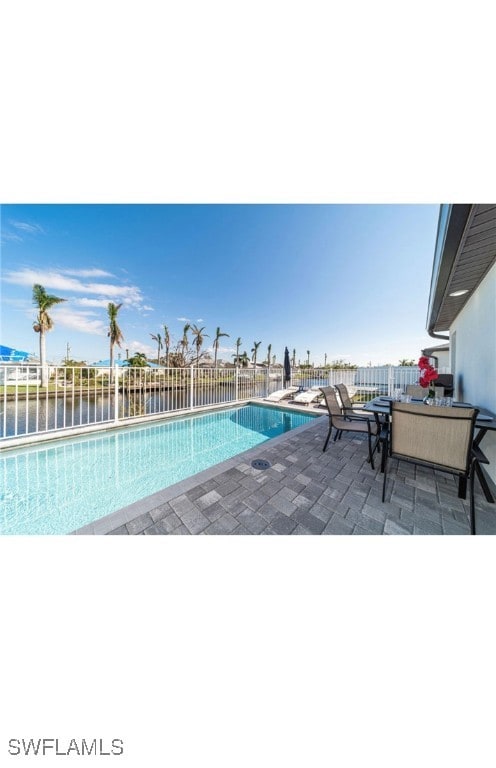 View of swimming pool with a patio area and a wate