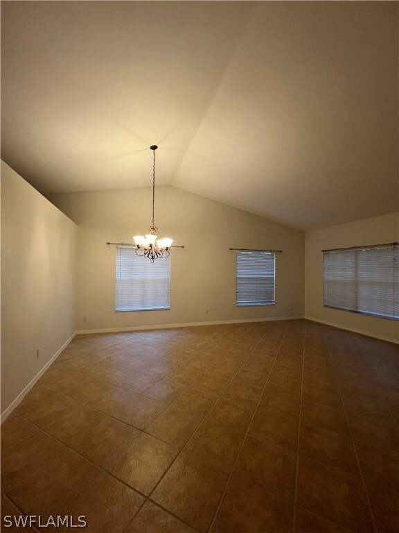 Empty room featuring tile floors, an inviting chan