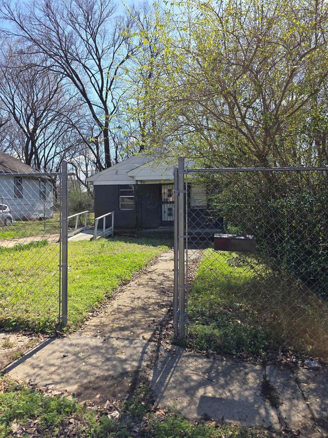 Exterior space with a gate and fence