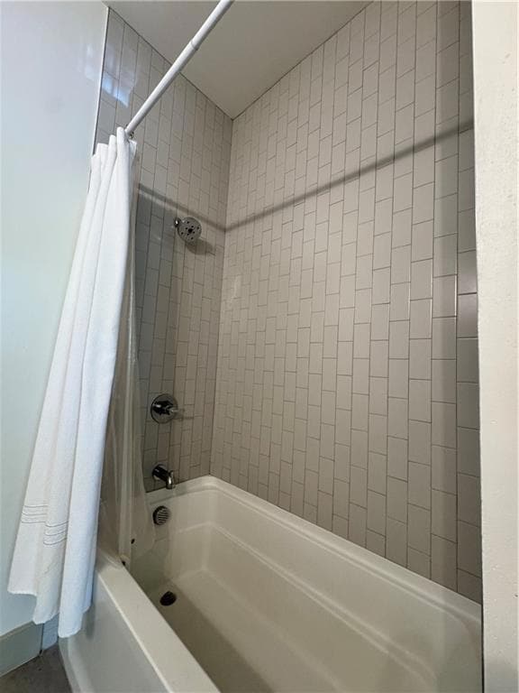 Full bath featuring shower / bath combo with showe