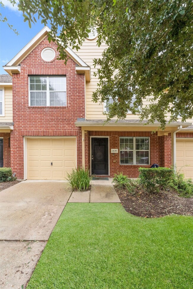 The front yard is perfectly shaded by the oak tree.