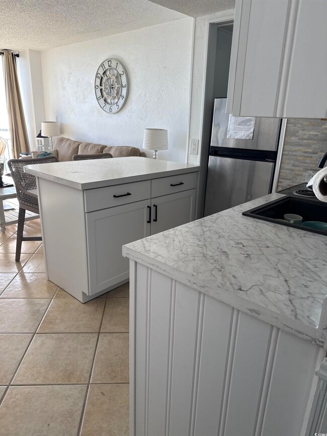 Kitchen featuring brand new white cabinets, light 