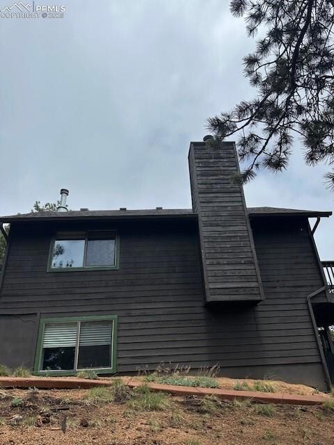 View of side of home with a chimney