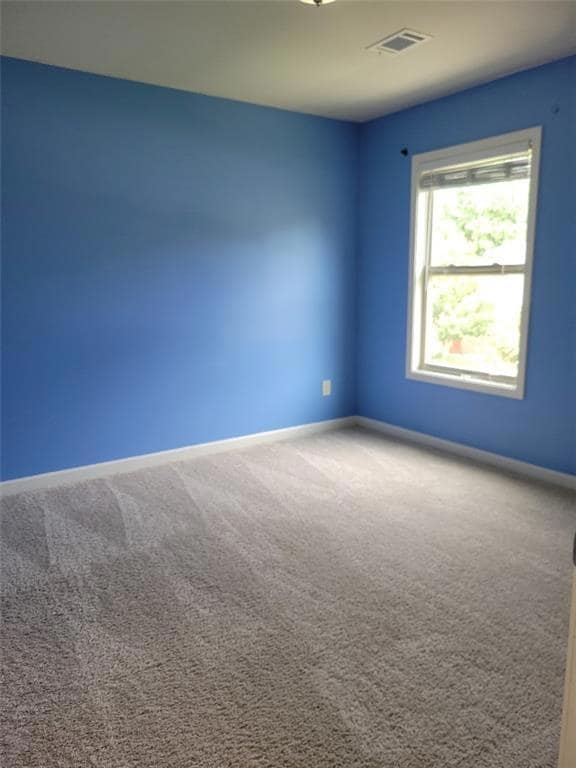 Spare room featuring carpet floors