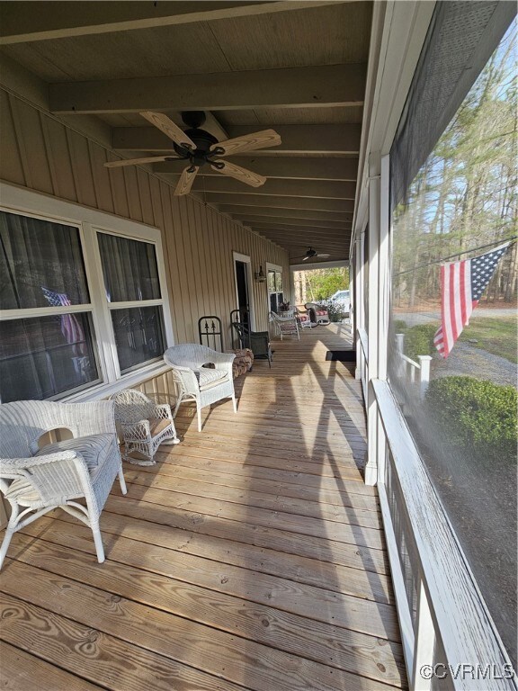 Screened front porch featuring ceiling fan