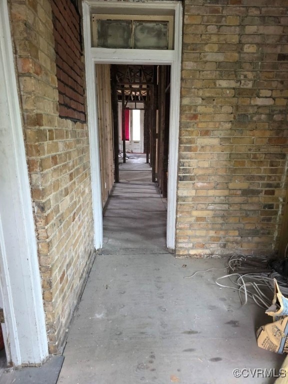 Entrance to property featuring brick siding
