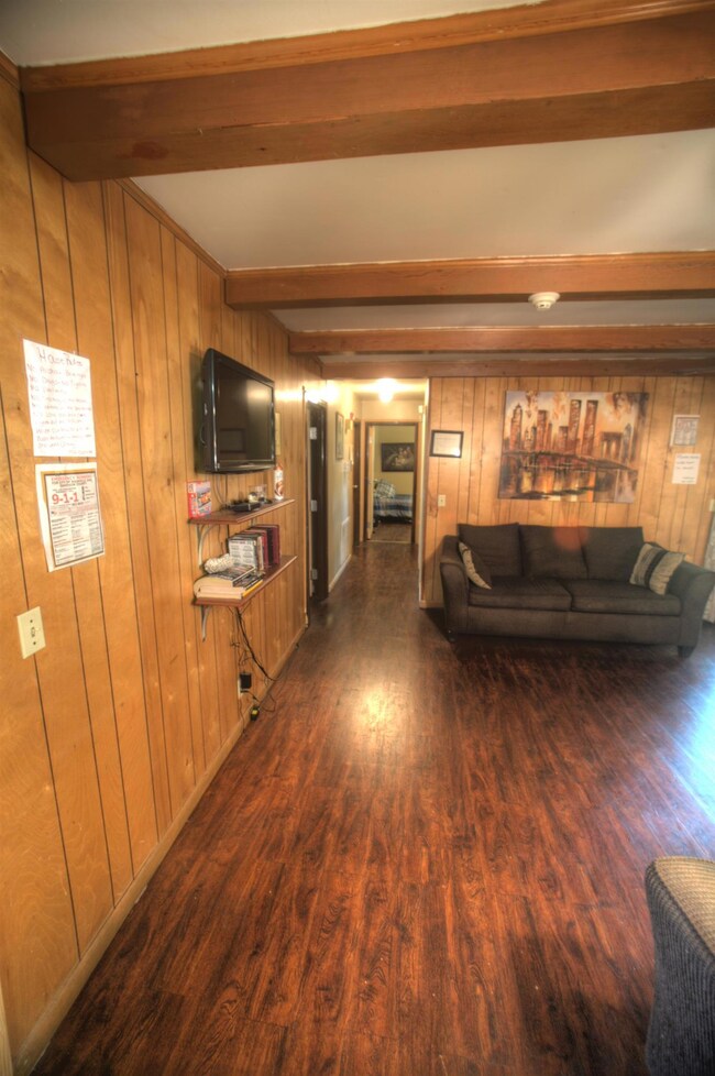Notice the wooden beams and gleaming hardwood floors.