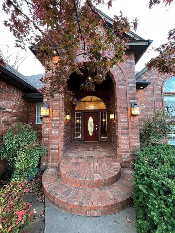 View of exterior entry with brick siding