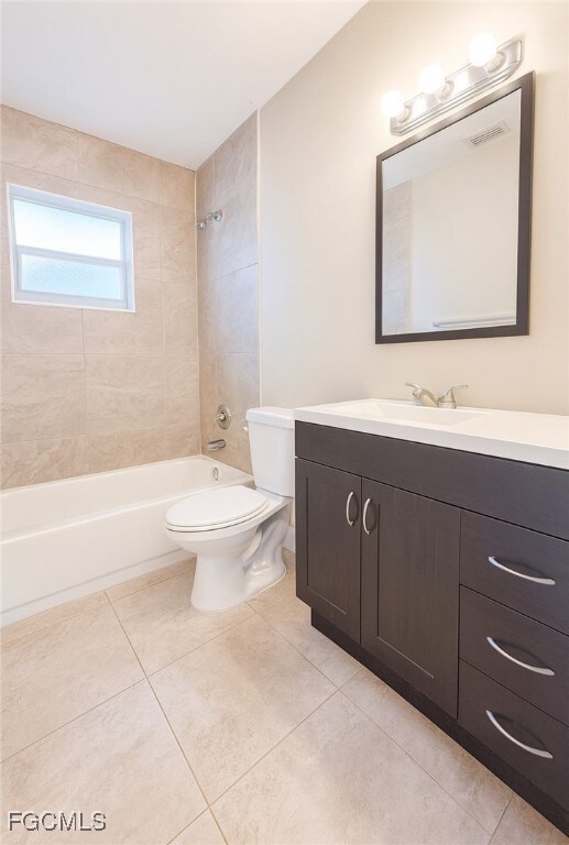 Bathroom with vanity,  shower combination, and light tile patterned flooring