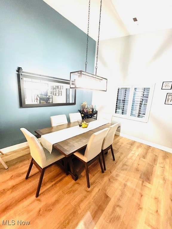 Dining room with baseboards and light wood-style floors