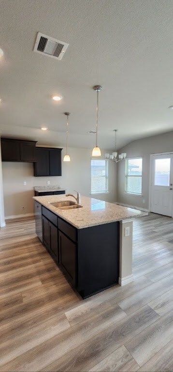Kitchen featuring sink, an inviting chandelier, li