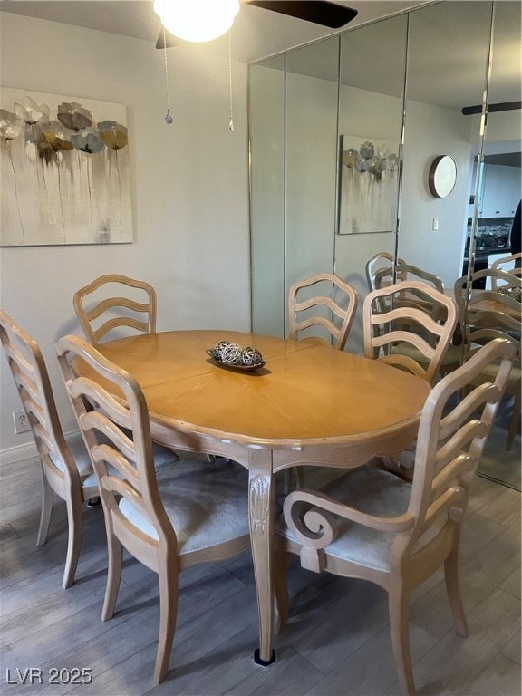 Dining room with wood finished floors and ceiling fan