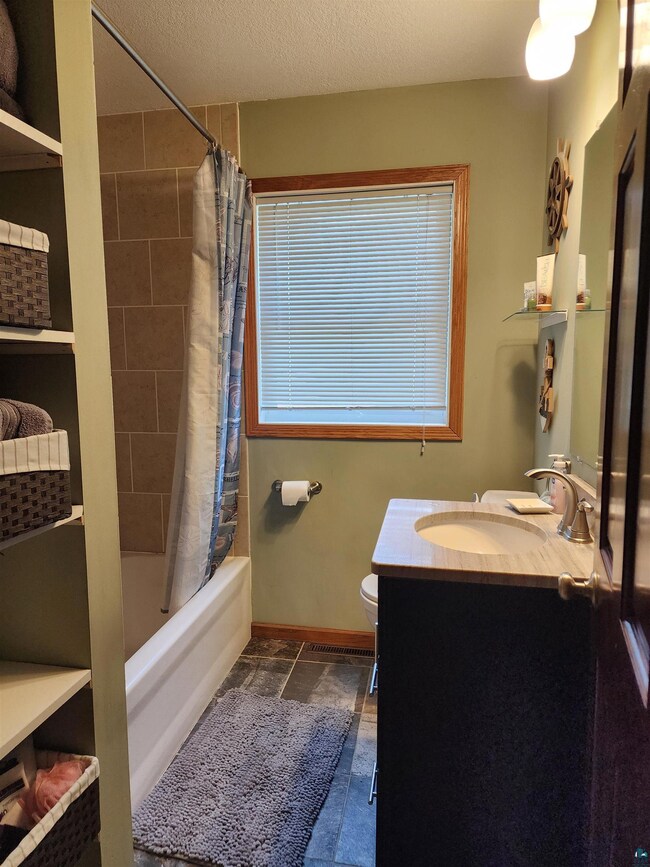 Full bathroom with tile flooring, toilet, shower /